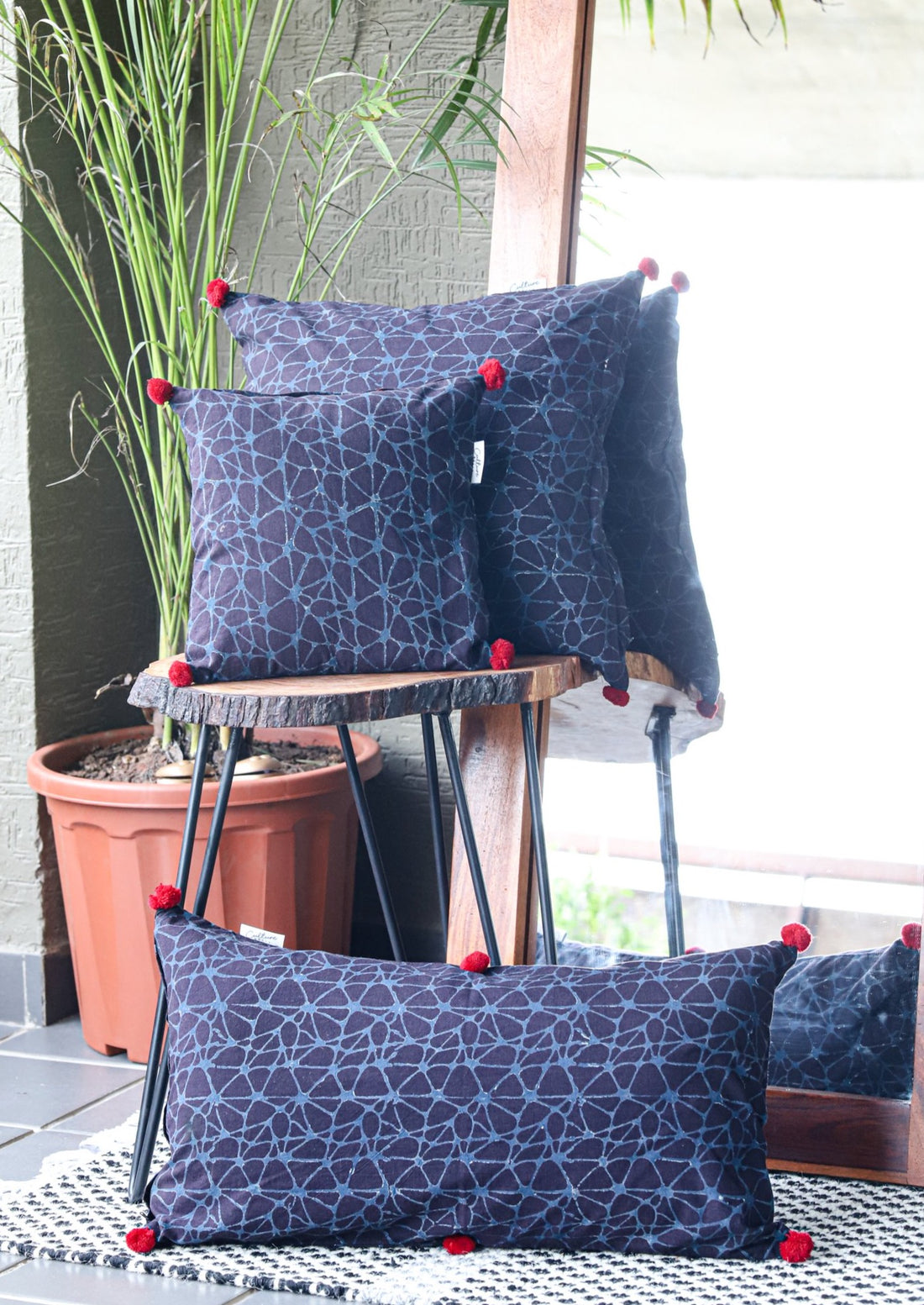 Set of 3 Dhara Ajrakh Block Printed Indigo Cushion Covers in sizes 11x11, 16x16, and 22x12, featuring intricate traditional patterns on soft indigo fabric.