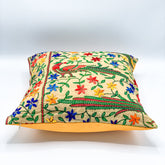 "16x16 inch cushion cover featuring vibrant block printed patterns and intricate hand embroidery, adding a touch of artisanal charm to any space."