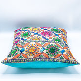 "Block printed and hand embroidered cushion cover in 18x18 size featuring intricate floral designs and vibrant colors, perfect for adding a touch of artistry to your home decor."