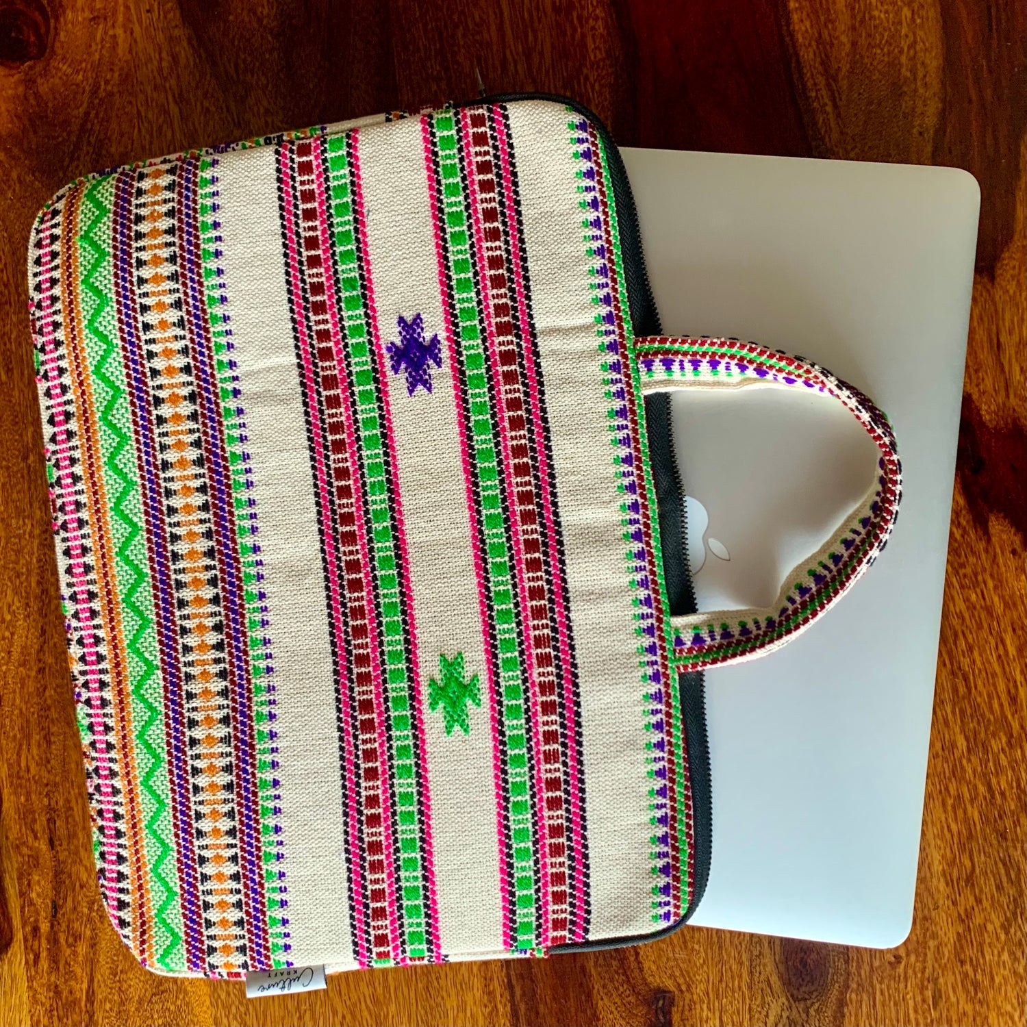 KORA Handloom Jacquard Laptop Bag featuring intricate handwoven patterns in vibrant colors, showcasing a stylish and functional design perfect for carrying laptops and essentials