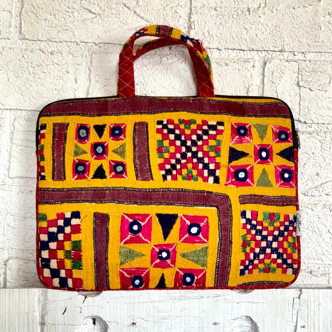 &quot;CHAKDA - Vintage Kutch Embroidery Laptop Bag featuring intricate hand-stitched patterns in vibrant colors, combining traditional craftsmanship with modern functionality.&quot;