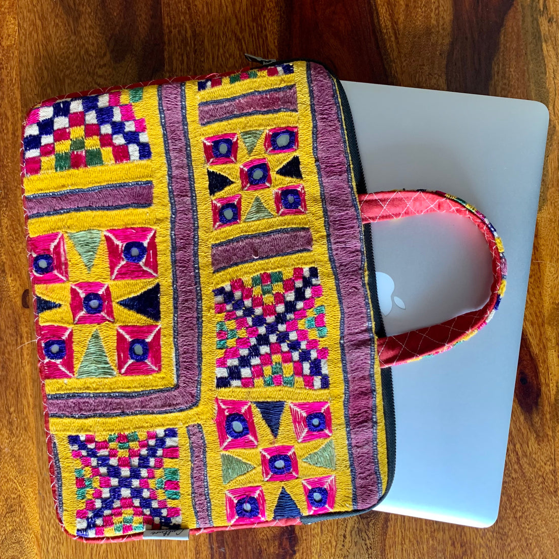 &quot;CHAKDA - Vintage Kutch Embroidery Laptop Bag featuring intricate hand-stitched patterns in vibrant colors, combining traditional craftsmanship with modern functionality.&quot;