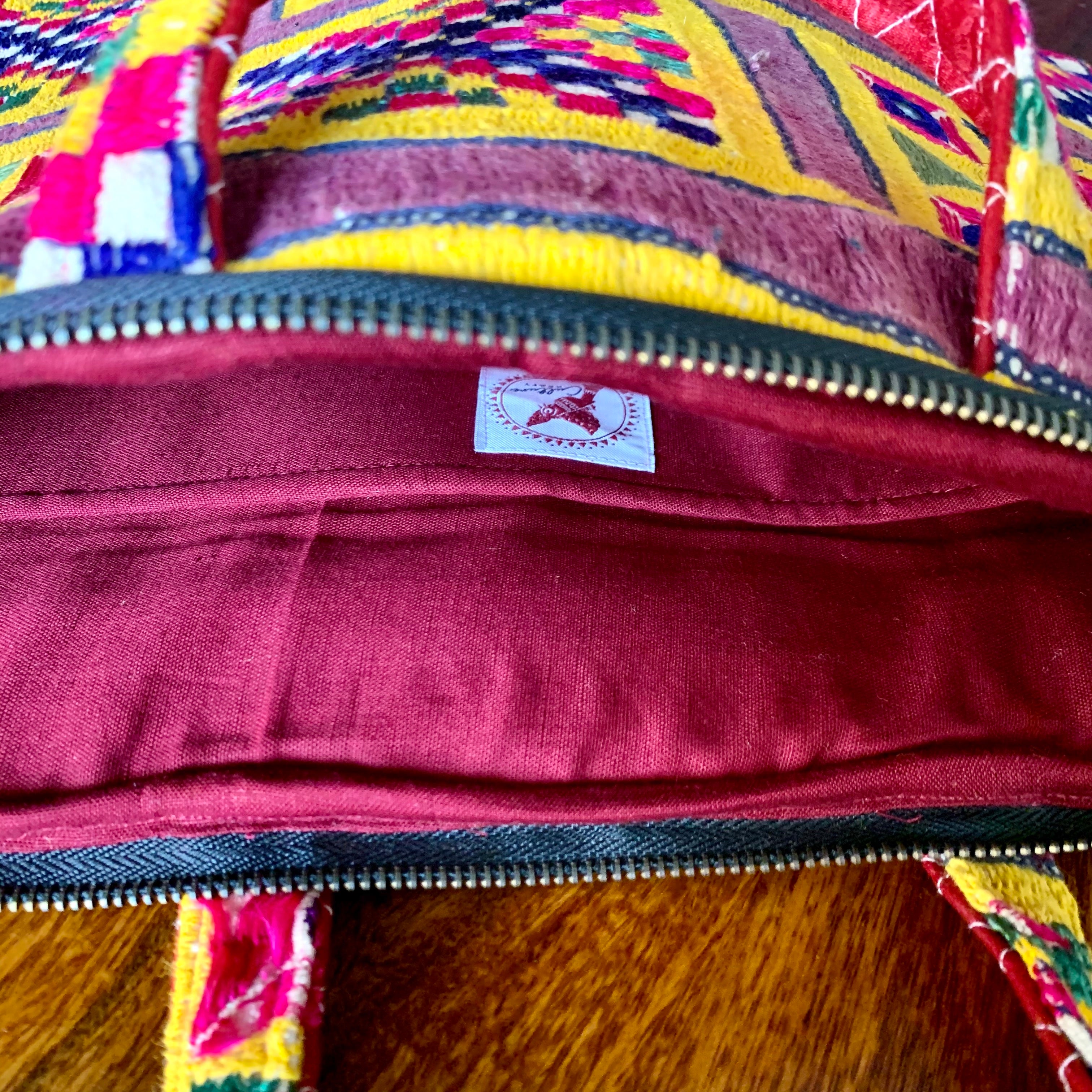 &quot;CHAKDA - Vintage Kutch Embroidery Laptop Bag featuring intricate hand-stitched patterns in vibrant colors, combining traditional craftsmanship with modern functionality.&quot;