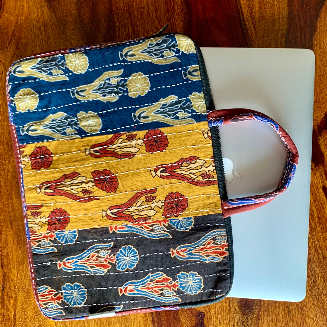 SOSAN Ajrakh Panelled Laptop Bag featuring vibrant handblock prints, a spacious interior, and sturdy straps, perfect for stylishly carrying your laptop and essentials.